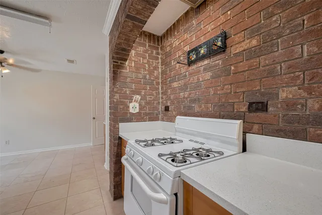 a stove top oven sitting inside of a kitchen