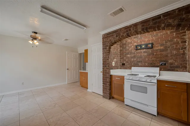 a view of a kitchen with stove and refrigerator