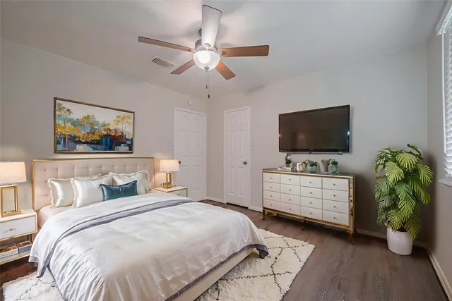 a bedroom with a bed and a flat screen tv