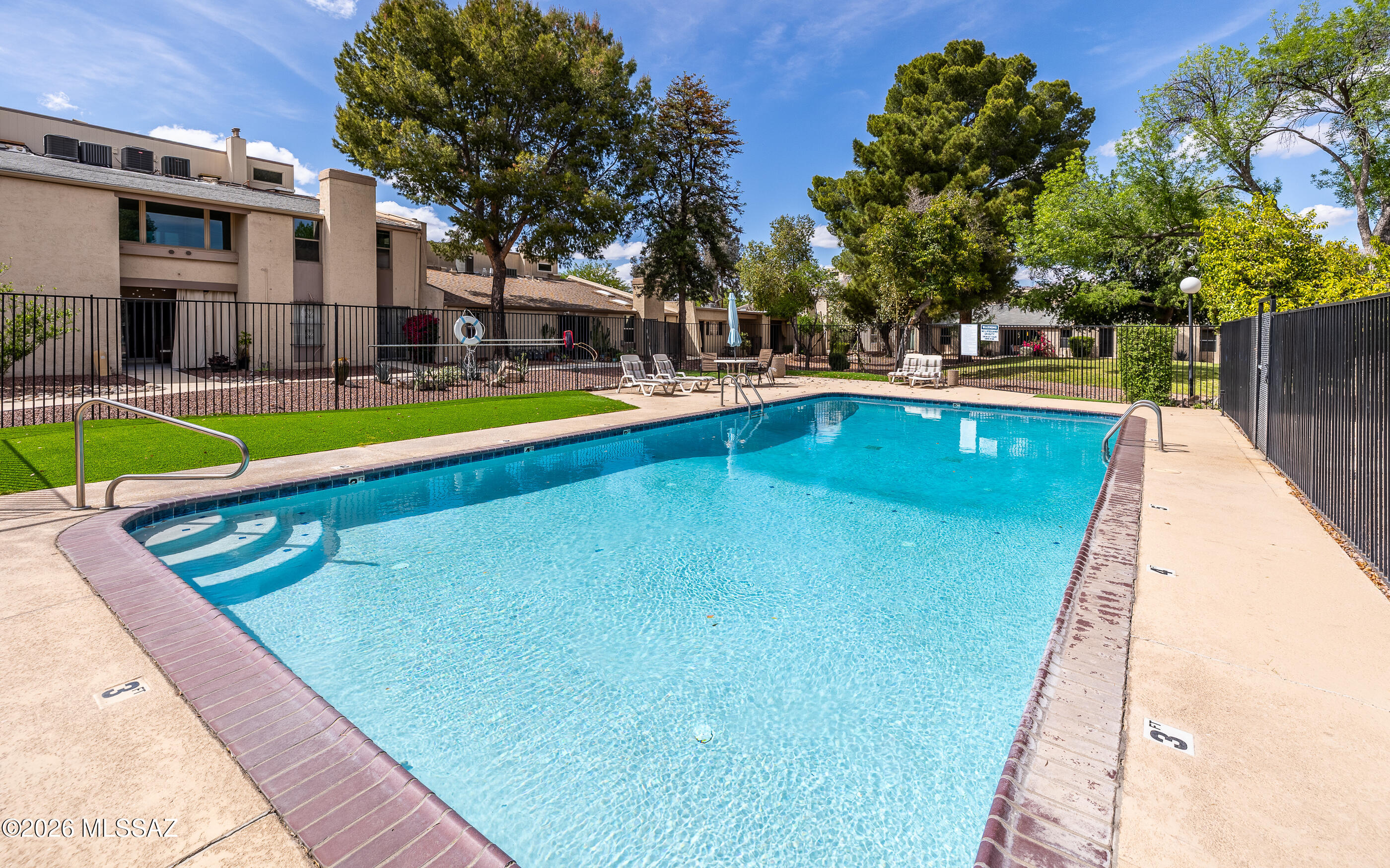 3750 North Country Club Road, Unit 46 Tucson, AZ 85716 - Photo 33 of 34 a swimming pool with outdoor seating and yard