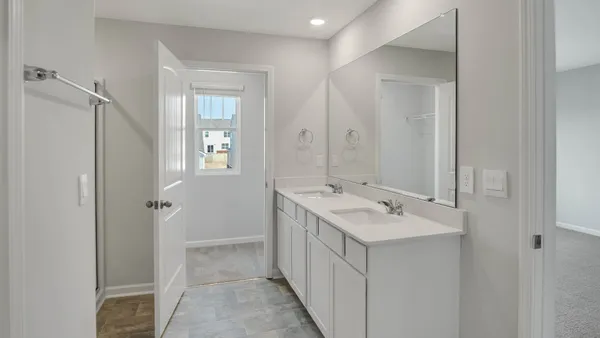 a bathroom with a sink a mirror and a shower