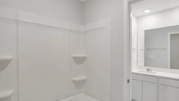 a bathroom with a granite countertop sink and mirror