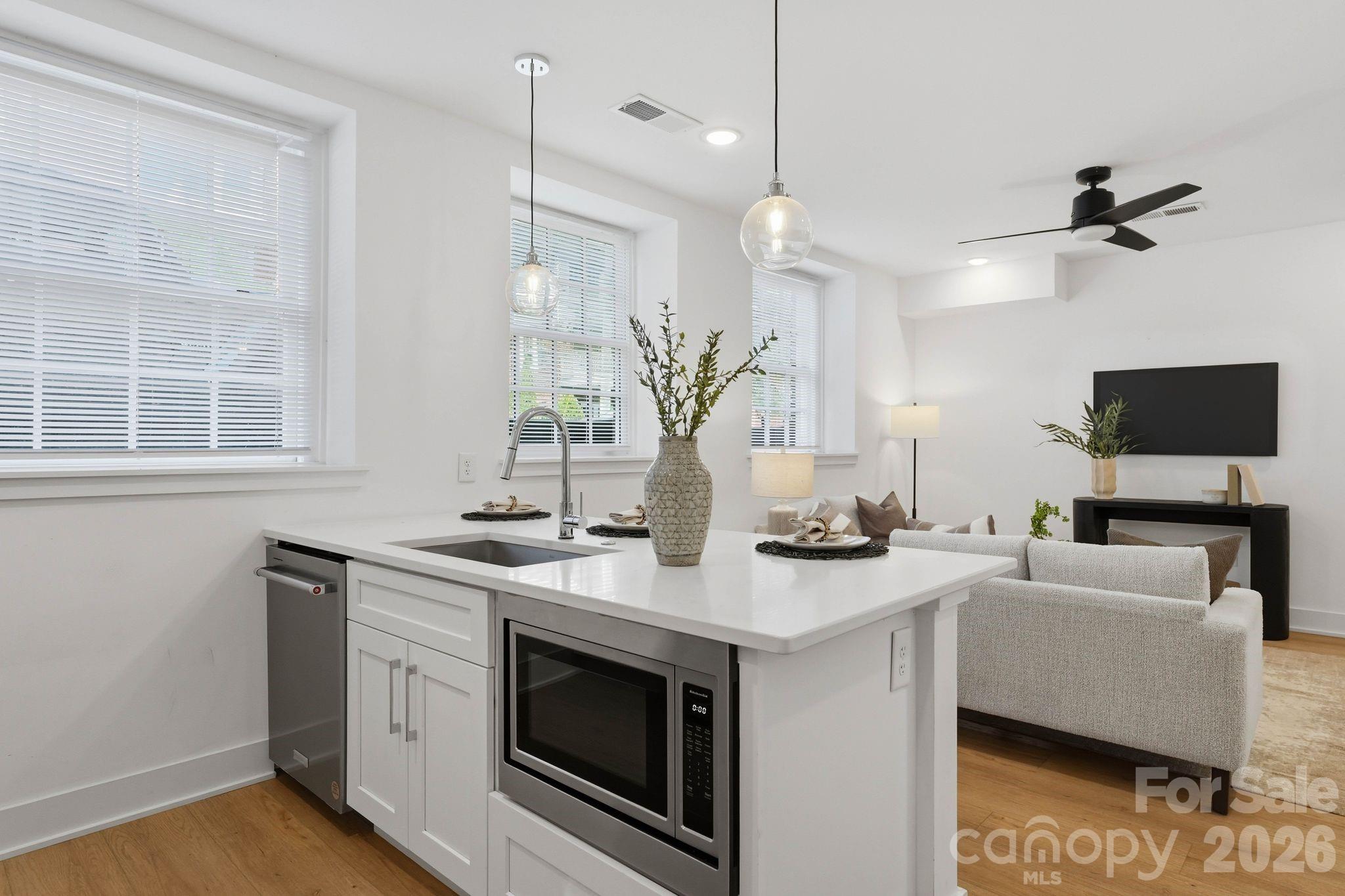 201 Grandin Road, Unit 6 Charlotte, NC 28208 - Photo 6 of 45 a kitchen with stainless steel appliances granite countertop a sink a stove and a wooden floors