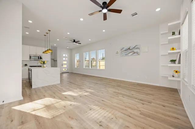 a view of a hallway with wooden floor and entryway