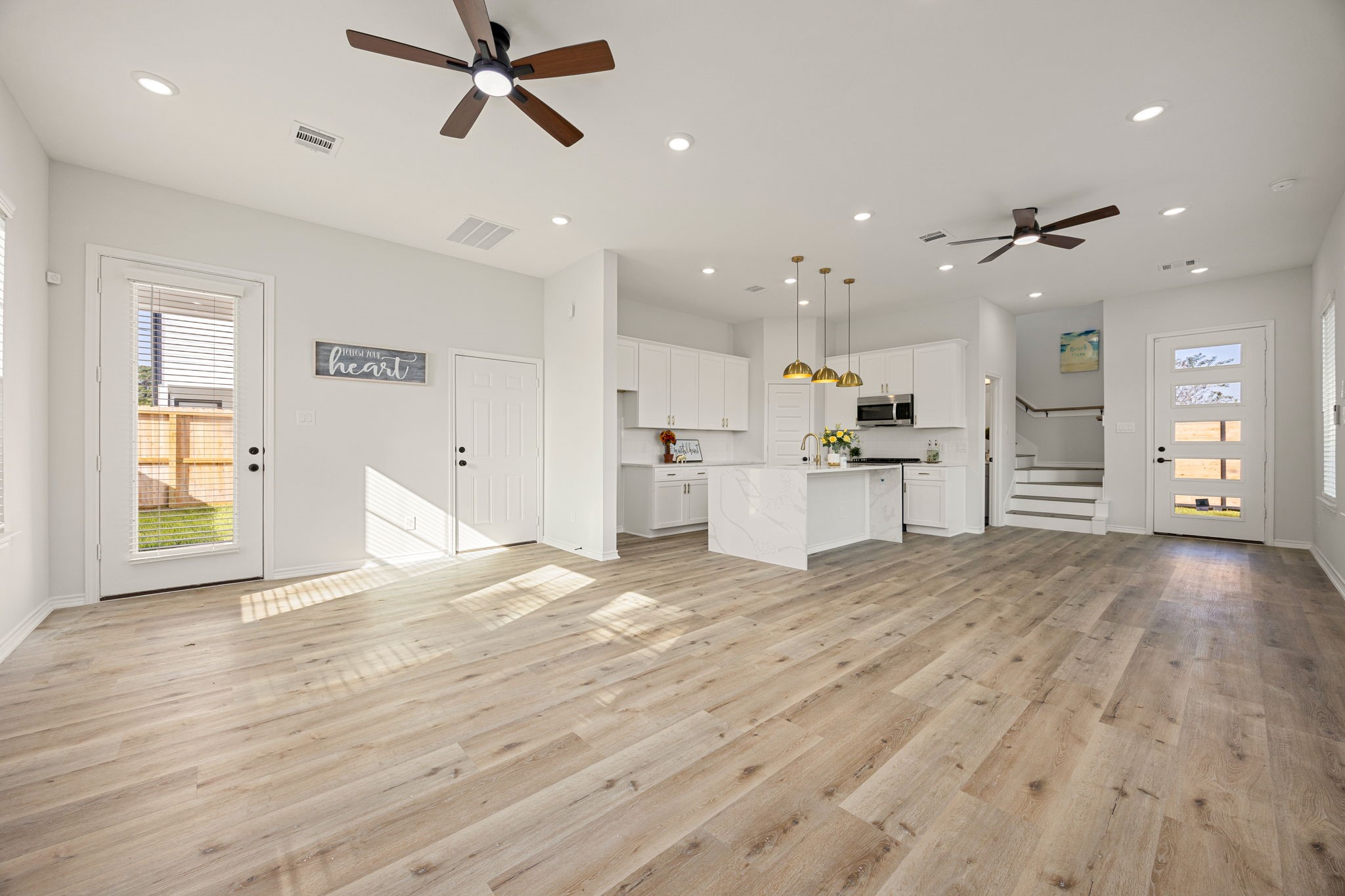 2720 Spence Street Houston, TX 77093 - Photo 12 of 50 a view of a kitchen with a stove cabinets and wooden floor