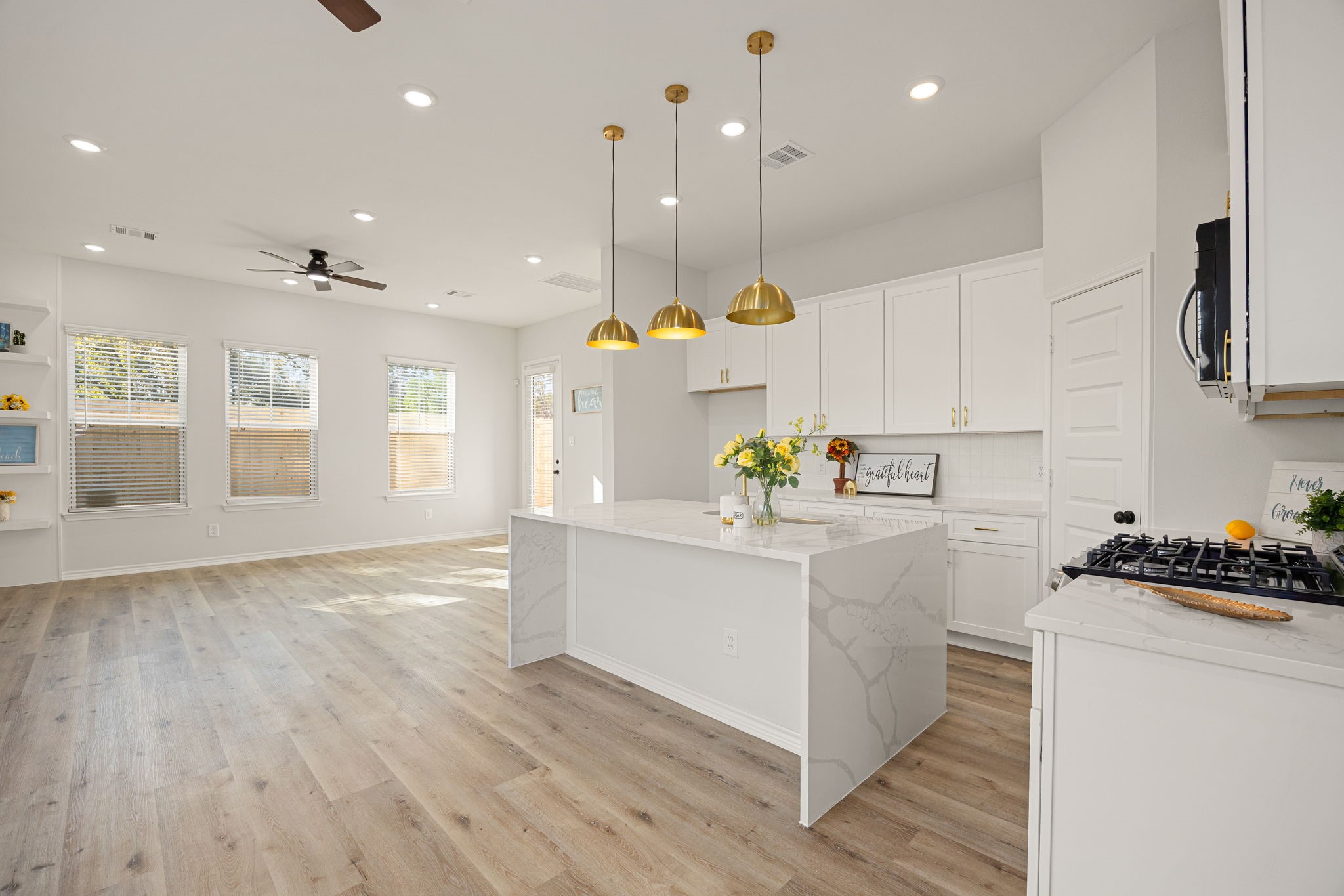 2720 Spence Street Houston, TX 77093 - Photo 15 of 50 a kitchen with stainless steel appliances granite countertop a sink a stove and a wooden floors