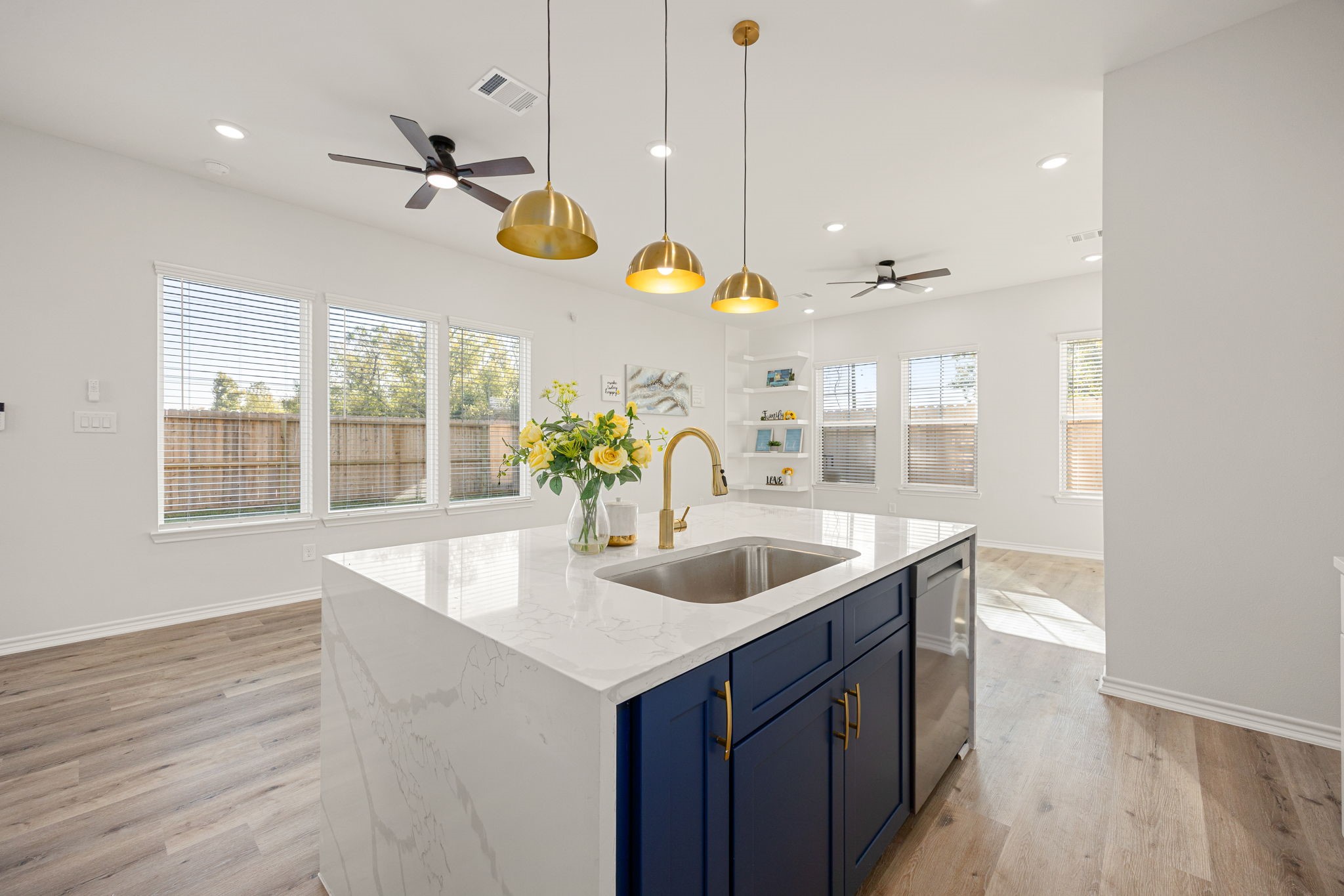 2720 Spence Street Houston, TX 77093 - Photo 18 of 50 a kitchen with a sink a counter space and a wooden floor