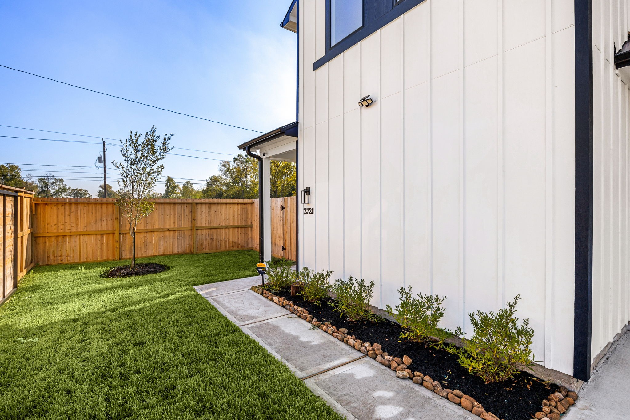 2720 Spence Street Houston, TX 77093 - Photo 38 of 50 a view of a backyard with potted plants and wooden fence