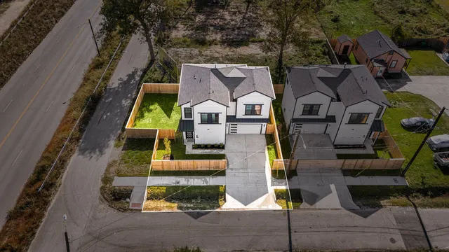 an aerial view of residential houses with outdoor space