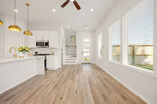 a kitchen with wooden floors and appliances