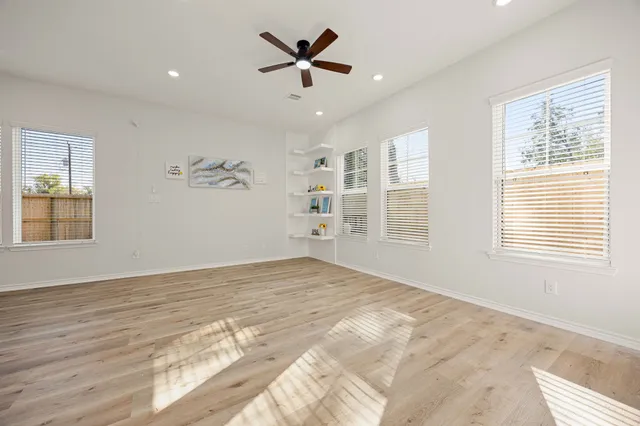 a view of a livingroom with a ceiling fan and window