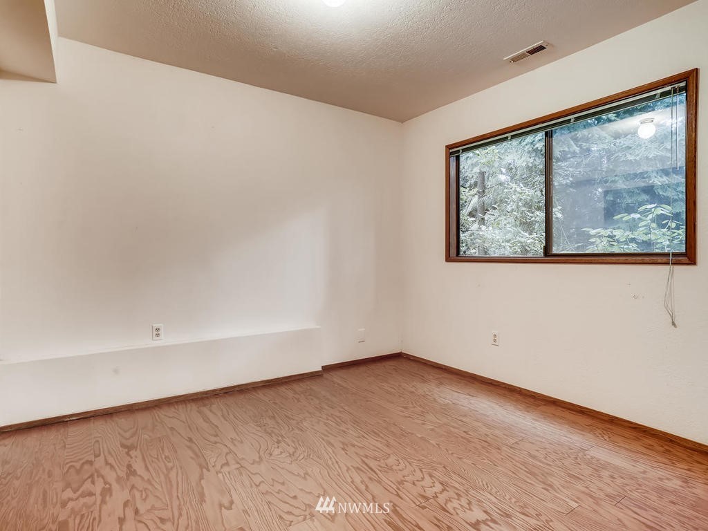 20931 29th Avenue Southeast Bothell, WA 98021 - Photo 23 of 32 a view of a big room with wooden floor and windows