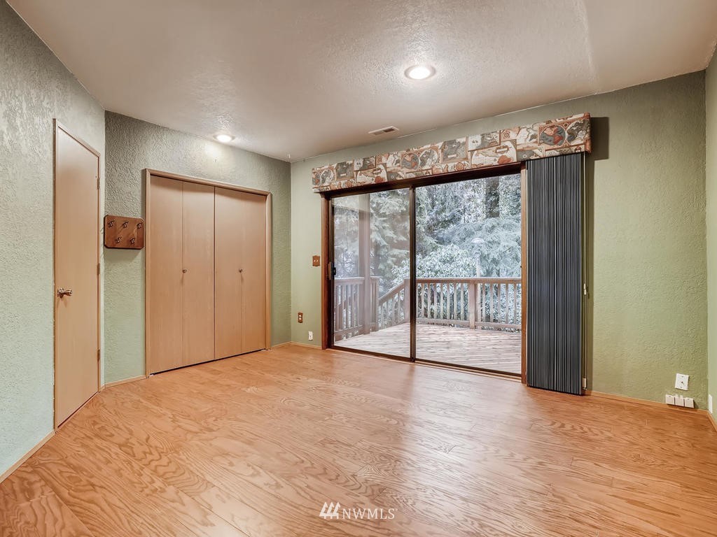 20931 29th Avenue Southeast Bothell, WA 98021 - Photo 24 of 32 a view of an empty room with wooden floor and a window