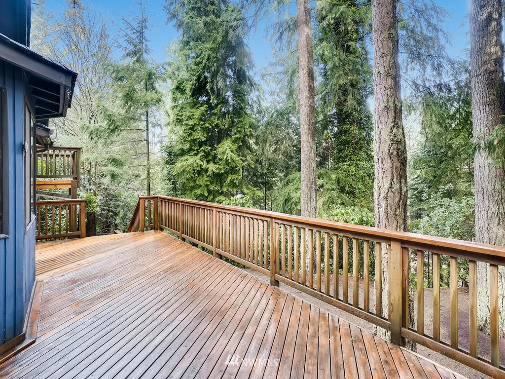 20931 29th Avenue Southeast Bothell, WA 98021 - Photo 30 of 32 a balcony with wooden floor and yard in the back