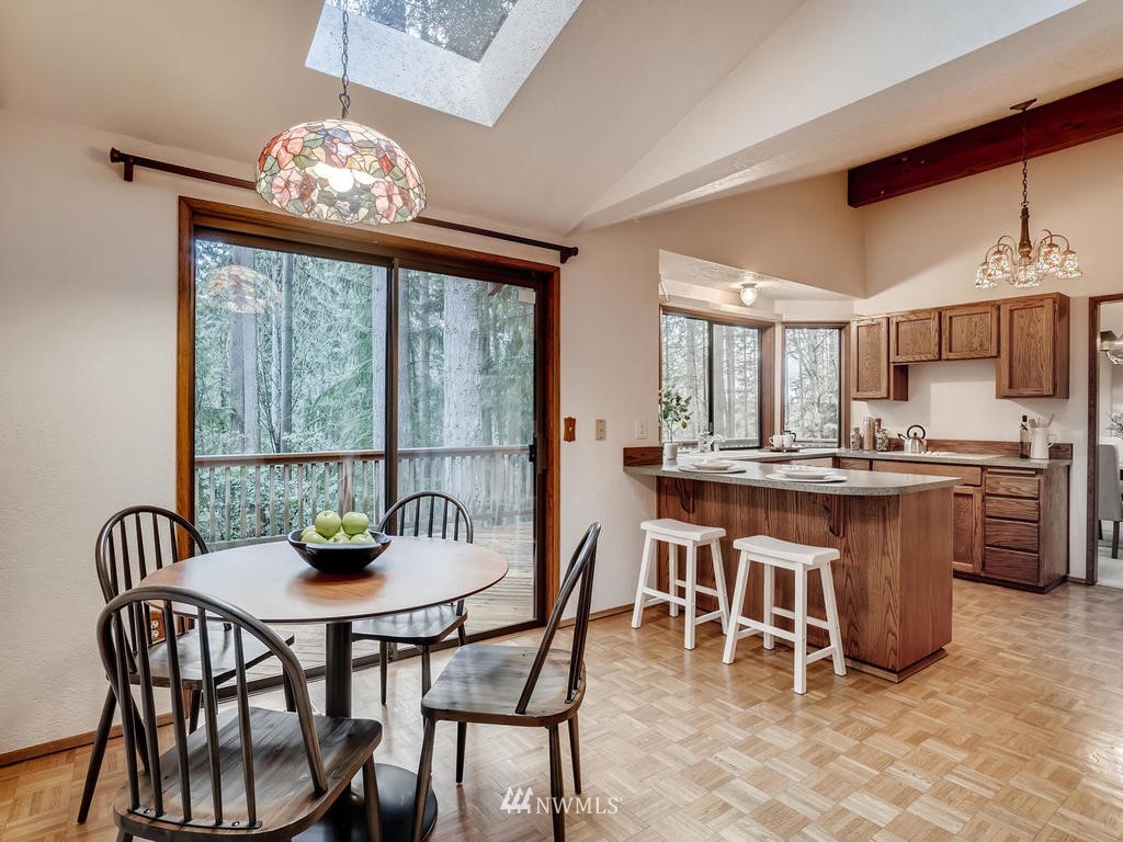 20931 29th Avenue Southeast Bothell, WA 98021 - Photo 10 of 32 a dining room filled chandelier and wooden floor