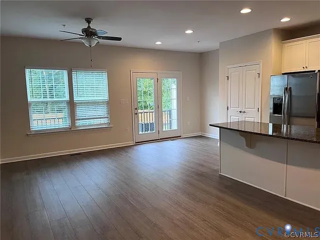 a kitchen with granite countertop a stove top oven a sink a counter space and cabinets