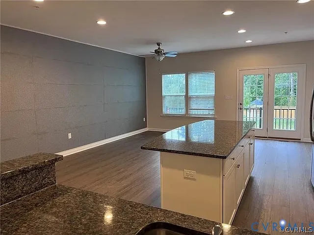 a hallway with sliding door and wooden floor