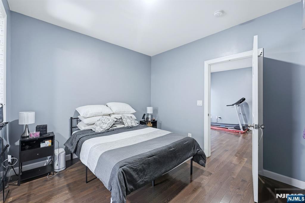 757 Thomas Street Elizabeth, NJ 07202 - Photo 14 of 38 a bedroom with a bed and a wooden floor