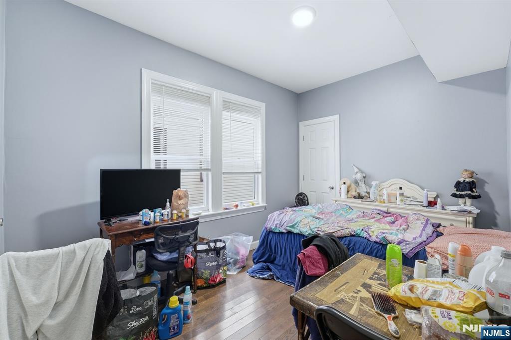 757 Thomas Street Elizabeth, NJ 07202 - Photo 16 of 38 a bedroom with a bed and a flat screen tv
