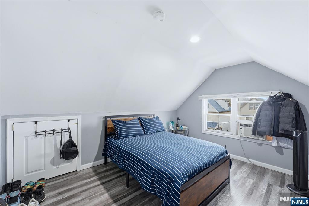757 Thomas Street Elizabeth, NJ 07202 - Photo 25 of 38 a bedroom with a bed and a dresser next to a window