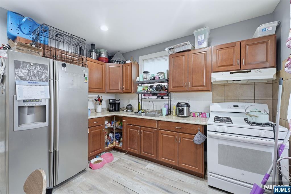 757 Thomas Street Elizabeth, NJ 07202 - Photo 27 of 38 a kitchen with stainless steel appliances granite countertop a refrigerator sink and cabinets