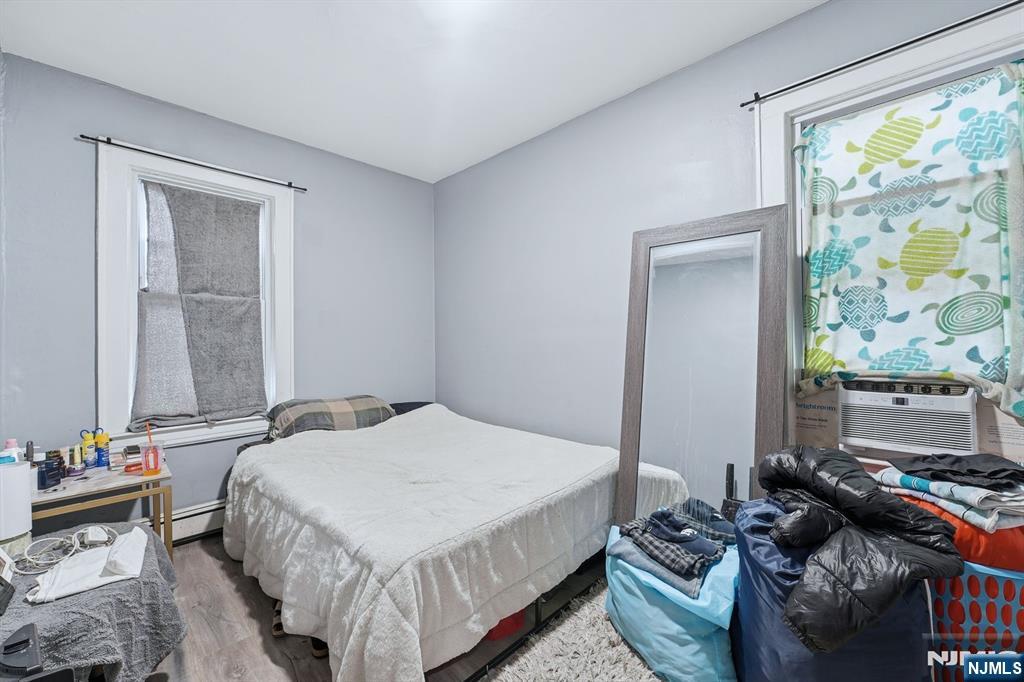 757 Thomas Street Elizabeth, NJ 07202 - Photo 28 of 38 a bedroom with a bed and wooden floor