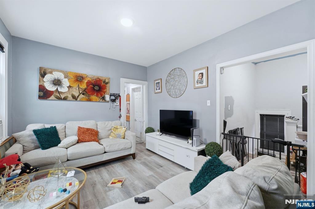 757 Thomas Street Elizabeth, NJ 07202 - Photo 29 of 38 a living room with furniture and a fireplace