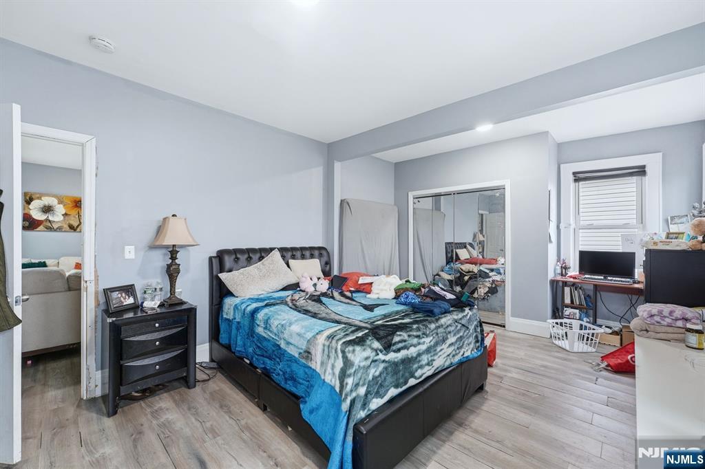 757 Thomas Street Elizabeth, NJ 07202 - Photo 31 of 38 a bedroom with bed and wooden floor