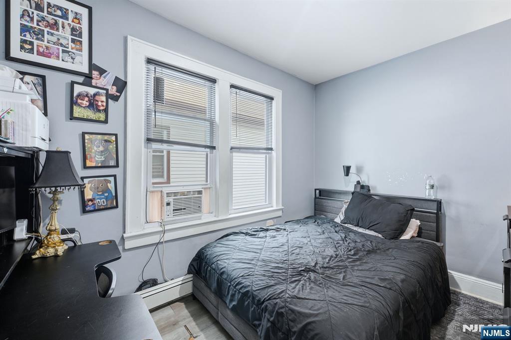 757 Thomas Street Elizabeth, NJ 07202 - Photo 32 of 38 a bedroom with a bed couch and a window