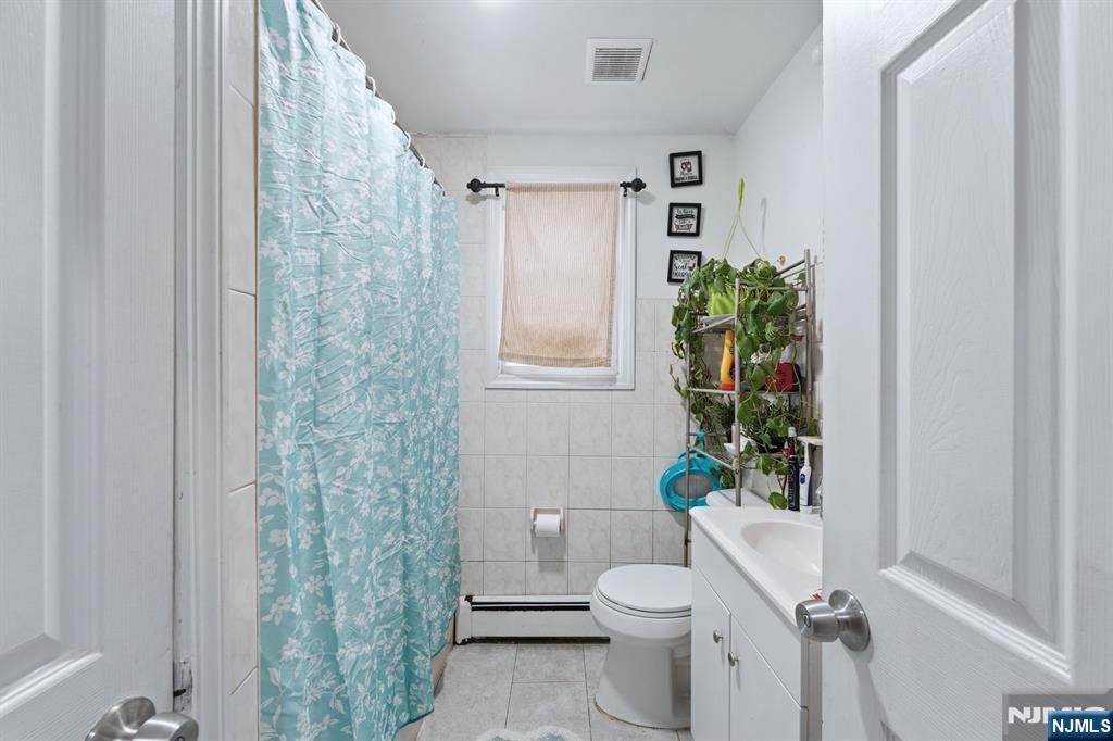 757 Thomas Street Elizabeth, NJ 07202 - Photo 33 of 38 a bathroom with a toilet and a shower curtain