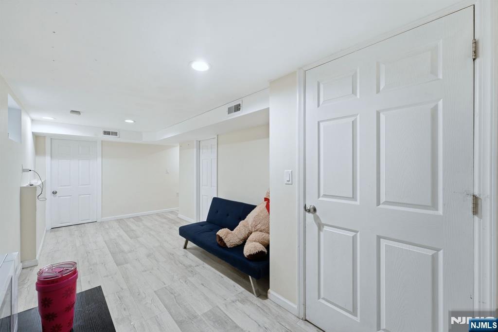 757 Thomas Street Elizabeth, NJ 07202 - Photo 35 of 38 a living room with furniture and a wooden floor