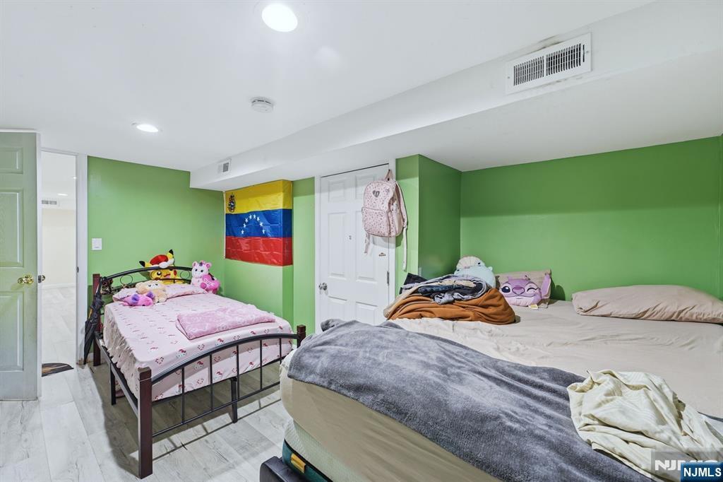 757 Thomas Street Elizabeth, NJ 07202 - Photo 36 of 38 a bedroom with a bed and large windows