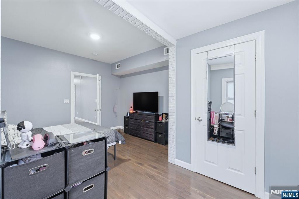 757 Thomas Street Elizabeth, NJ 07202 - Photo 37 of 38 a living room with furniture and a flat screen tv