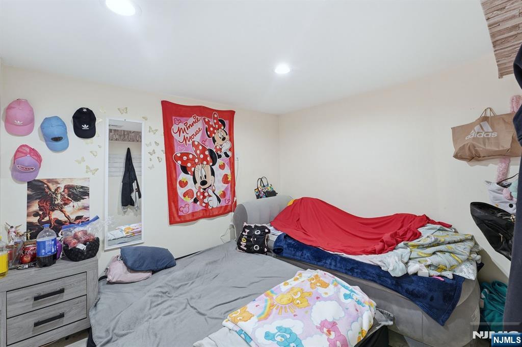 757 Thomas Street Elizabeth, NJ 07202 - Photo 6 of 38 a bedroom with two bed and a painting on the wall