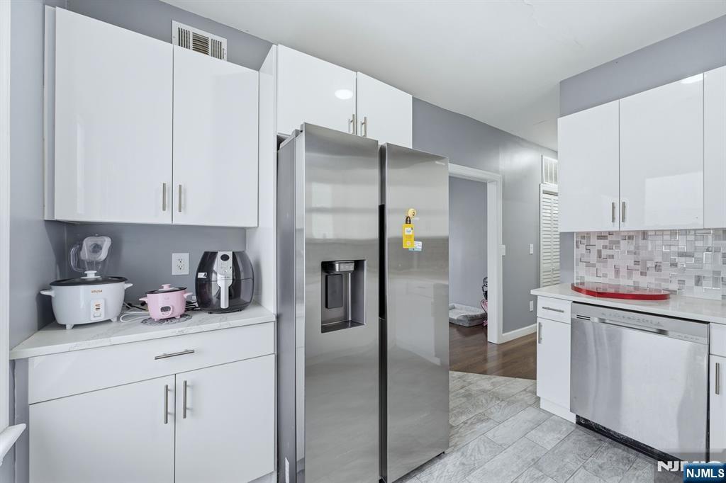 757 Thomas Street Elizabeth, NJ 07202 - Photo 9 of 38 a kitchen with a refrigerator and cabinets