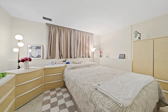 a large white bed in a white room