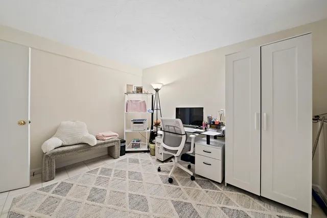 a view of a workspace with furniture and a window