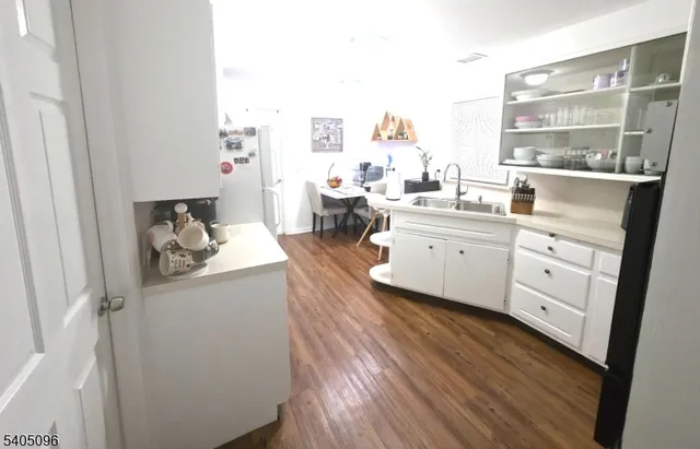 a kitchen with sink and cabinets
