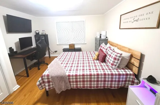 a bedroom with a bed and flat screen tv