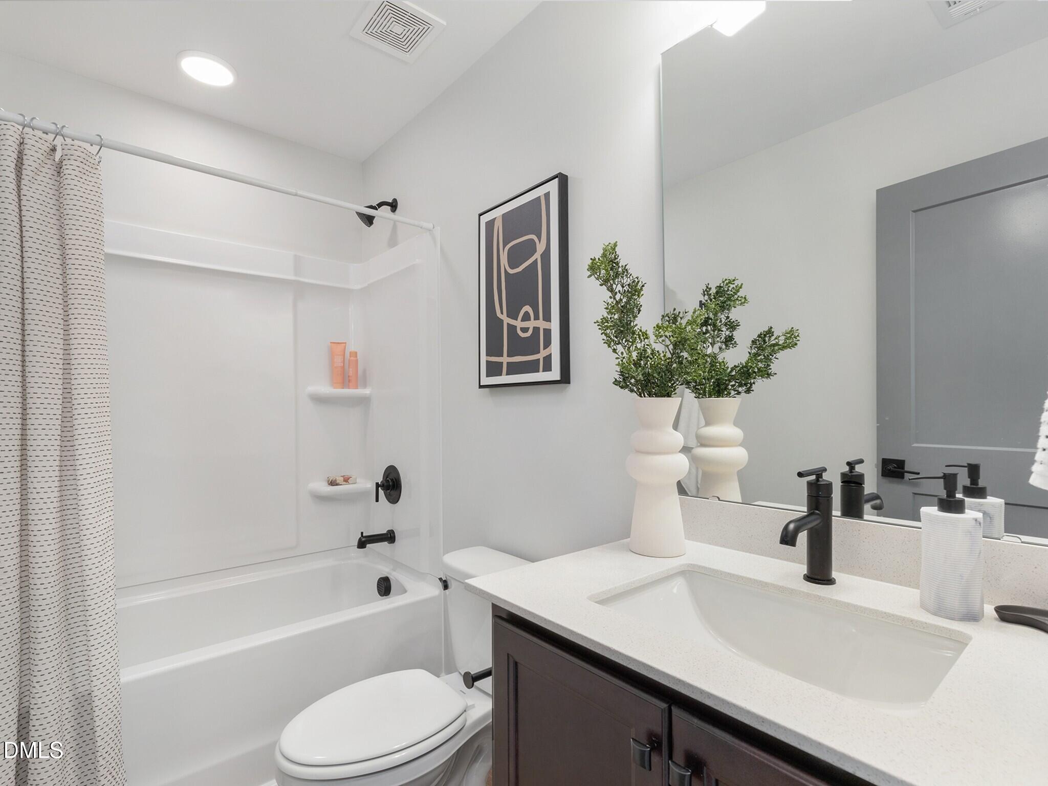 612 Cable Court Apex, NC 27523 - Photo 6 of 12 a bathroom with a sink a toilet and shower