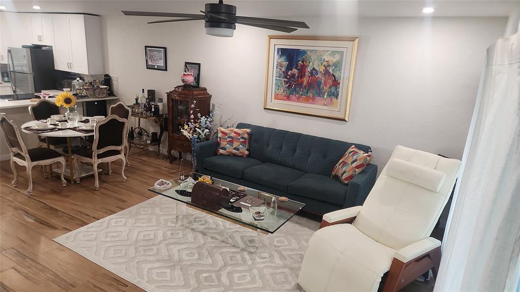 2202 Northeast 36th Street, Unit 15 Lighthouse Point, FL 33064 - Photo 11 of 47 a living room with furniture a flat screen tv and a table