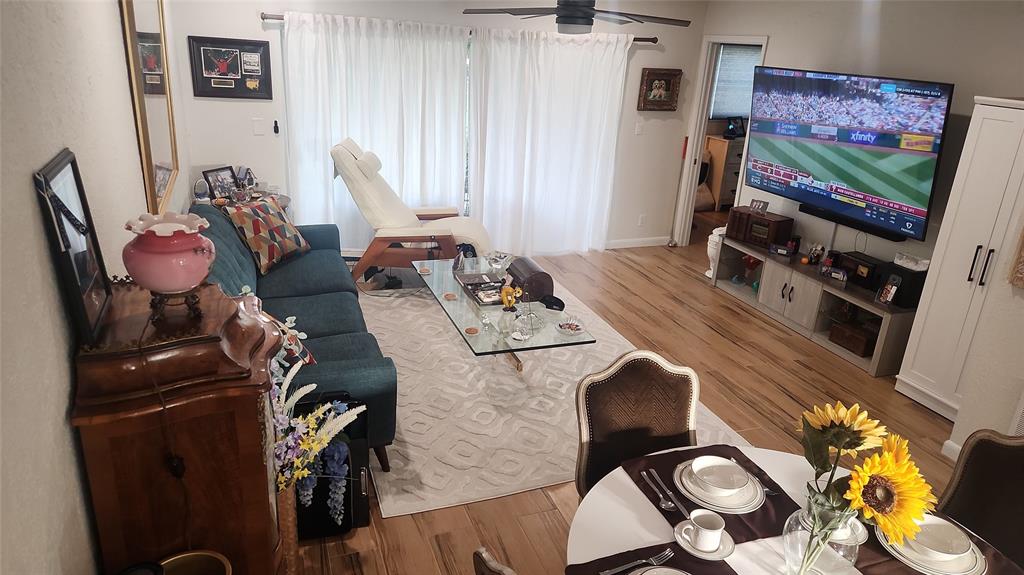 2202 Northeast 36th Street, Unit 15 Lighthouse Point, FL 33064 - Photo 13 of 47 a living room with furniture and wooden floor