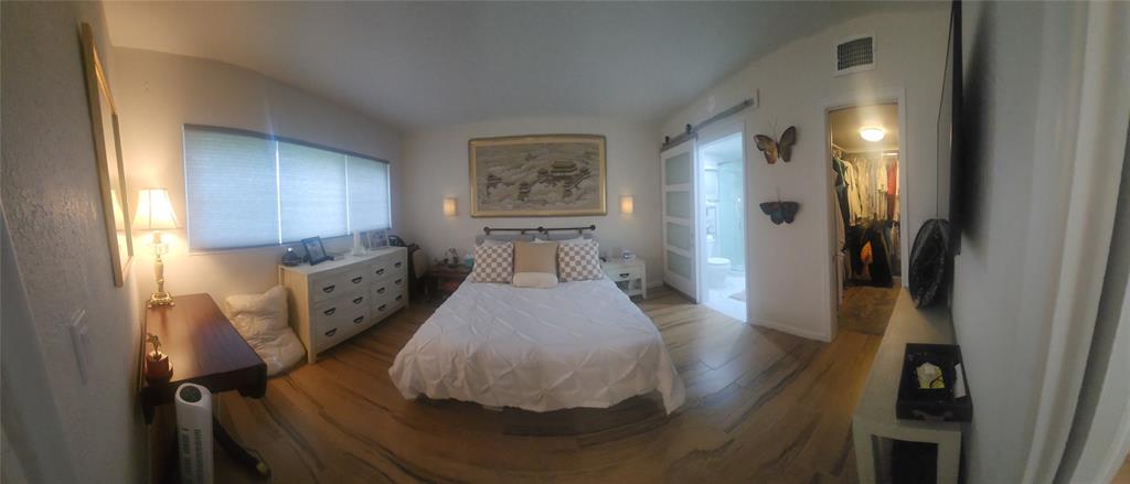 2202 Northeast 36th Street, Unit 15 Lighthouse Point, FL 33064 - Photo 21 of 47 a bed room with a bed and a painting