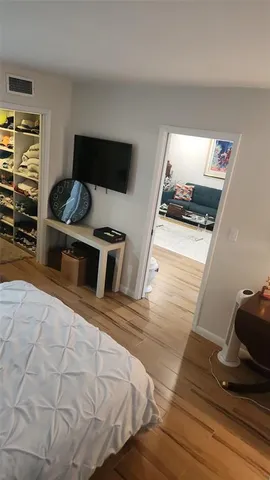 a bedroom with a bed and flat screen tv