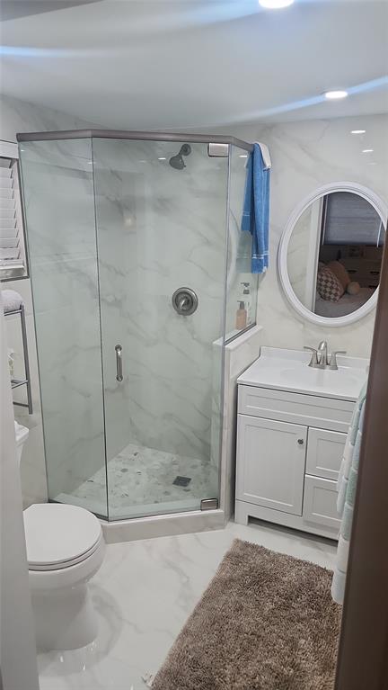 2202 Northeast 36th Street, Unit 15 Lighthouse Point, FL 33064 - Photo 29 of 47 a bathroom with a sink a toilet and shower