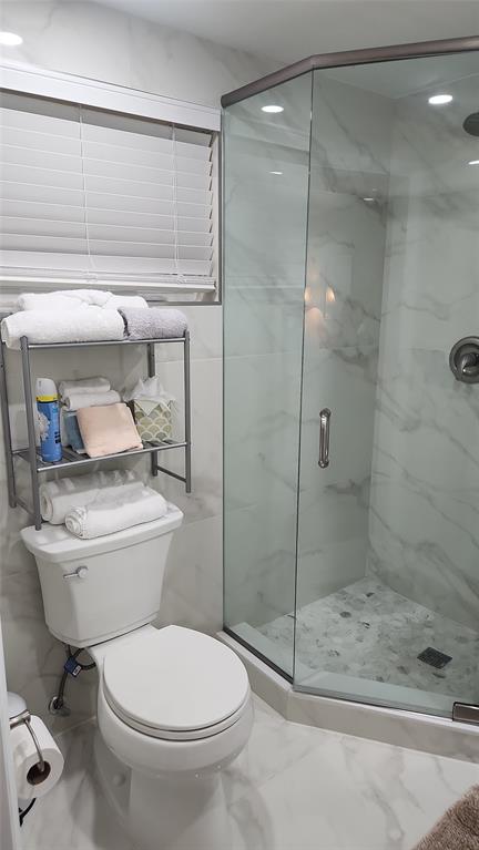 2202 Northeast 36th Street, Unit 15 Lighthouse Point, FL 33064 - Photo 30 of 47 a bathroom with a toilet and a shower
