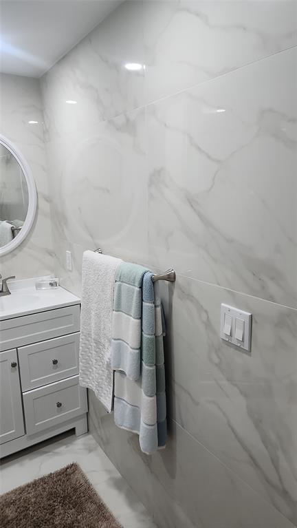 2202 Northeast 36th Street, Unit 15 Lighthouse Point, FL 33064 - Photo 32 of 47 a bathroom with a sink and a mirror