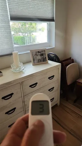 a living room with a bed and a window