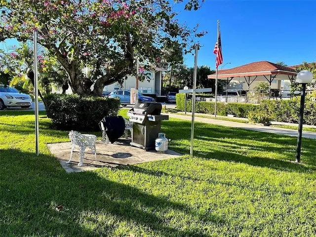 a view of a house with backyard and sitting area