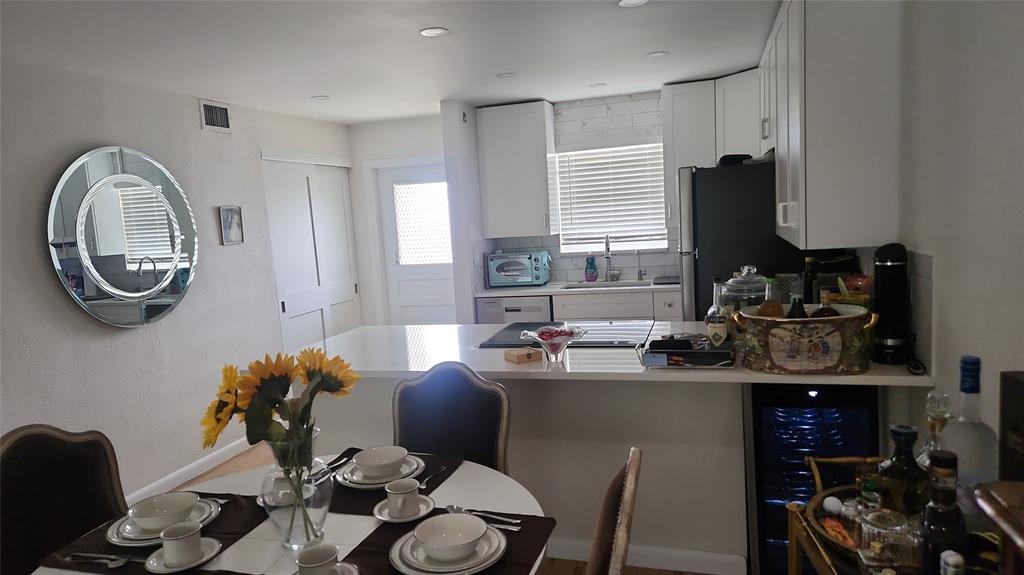 2202 Northeast 36th Street, Unit 15 Lighthouse Point, FL 33064 - Photo 6 of 47 a dining room with furniture and a mirror